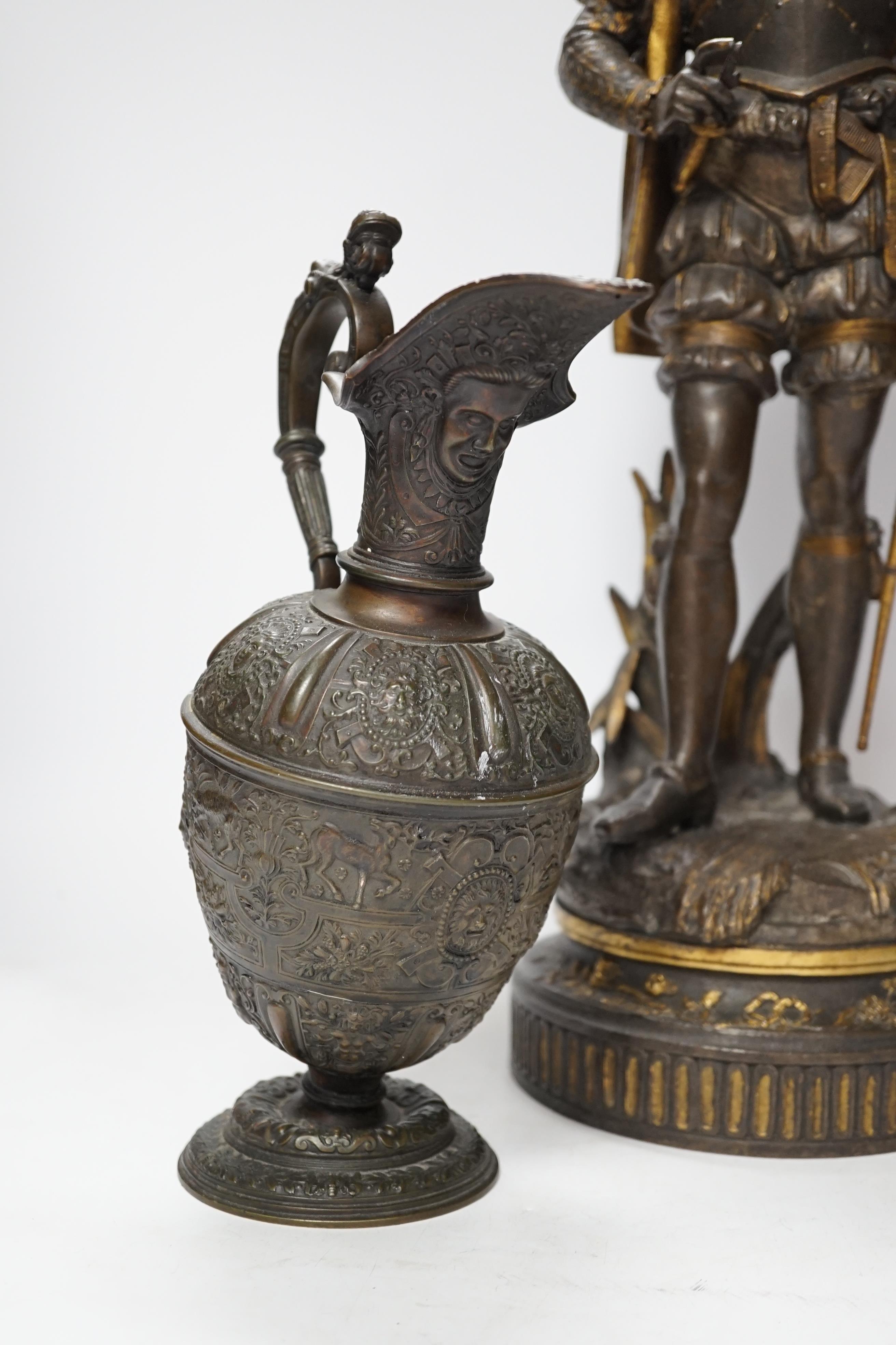 A 19th century parcel gilt and bronzed spelter figure of a cavalier, together with a Florentine style bronze ewer, 49cm high (the latter a.f.) (2)